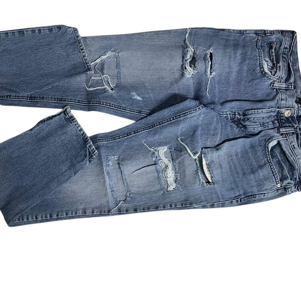 Distressed blue denim jeans
